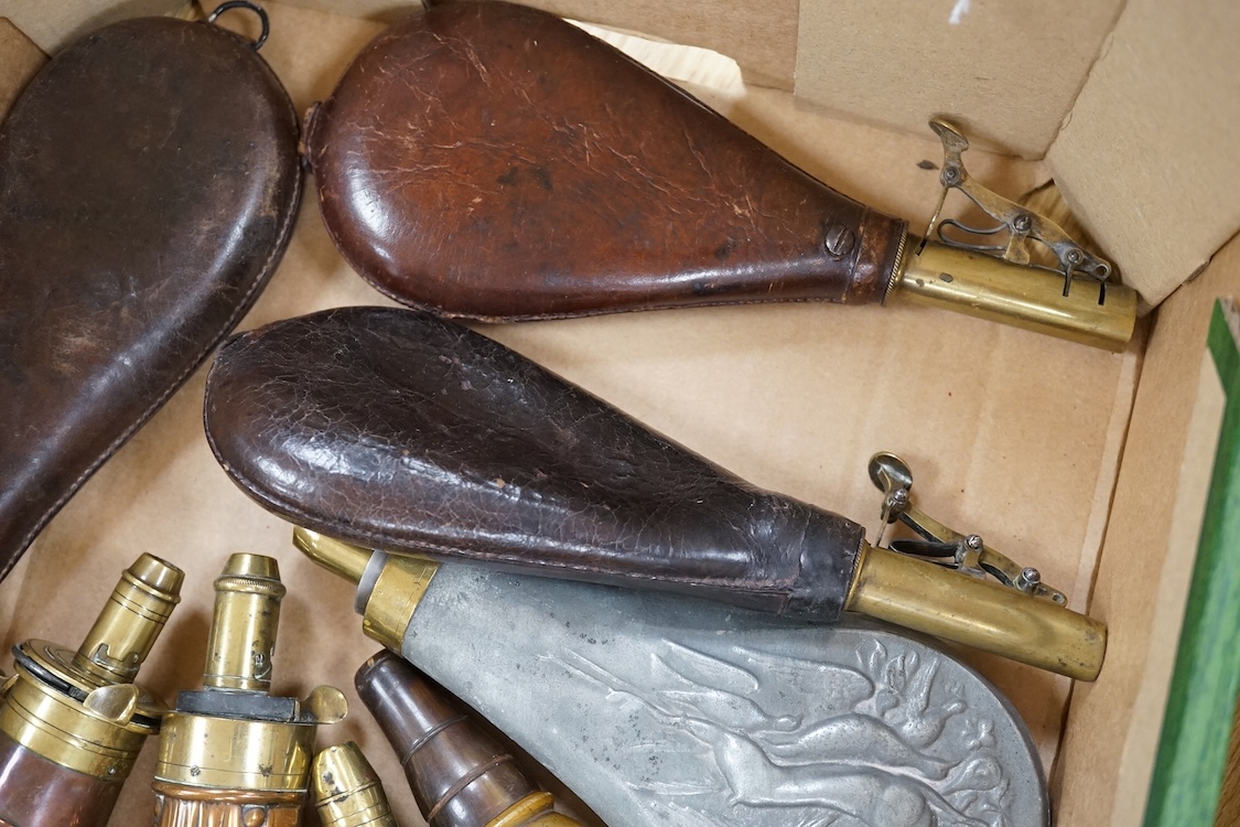 Nine powder flasks and shot flasks, all 19th century, comprising of two horn flasks, one flattened with brass mounts, three shot bags with sprung brass chargers, three copper gun flasks and another of zinc